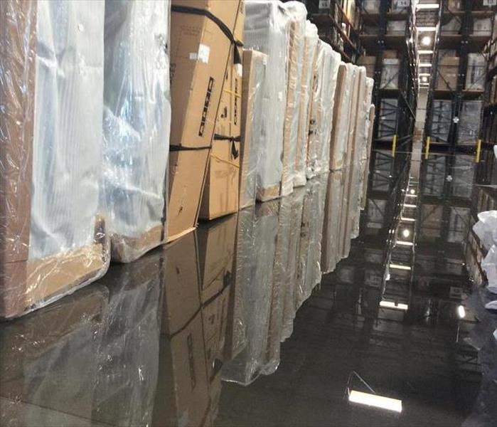 warehouse full of boxed furniture that have water damage